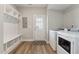 Convenient laundry room with washer, dryer, and built-in shelving at 107 York Dr, Oxford, NC 27565