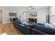 Living area with blue sofa, hardwood floors, and flat-screen TV at 107 York Dr, Oxford, NC 27565