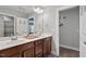 Double vanity bathroom with modern finishes and a linen closet at 1109 Timbercut Dr, Durham, NC 27703