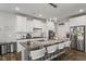 Modern kitchen with large island, granite countertops, and white cabinets at 1109 Timbercut Dr, Durham, NC 27703