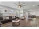Spacious living room with hardwood floors, large windows, and comfortable seating area at 1109 Timbercut Dr, Durham, NC 27703