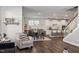 Open living room features hardwood floors, a cozy seating area, and views into the kitchen and dining area at 1109 Timbercut Dr, Durham, NC 27703
