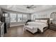 Main bedroom with hardwood floors, large windows, and a comfortable sitting area at 1109 Timbercut Dr, Durham, NC 27703