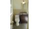 Updated bathroom with dark vanity and toilet at 1202 Vandora Ave, Garner, NC 27529