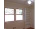 Well-lit bedroom with built-in shelving and hardwood floors at 1202 Vandora Ave, Garner, NC 27529