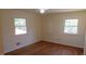 Bright bedroom with hardwood floors and two large windows at 1202 Vandora Ave, Garner, NC 27529