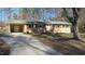 Ranch style home with brick facade, driveway, and mature trees at 1202 Vandora Ave, Garner, NC 27529