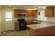 Galley style kitchen with granite countertops and stainless steel appliances at 1202 Vandora Ave, Garner, NC 27529