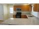 L-shaped kitchen with granite countertops and stainless steel appliances at 1202 Vandora Ave, Garner, NC 27529