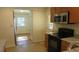Kitchen with granite countertops, stainless steel appliances, and access to backyard at 1202 Vandora Ave, Garner, NC 27529