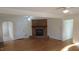 Spacious living room with hardwood floors and brick fireplace at 1202 Vandora Ave, Garner, NC 27529
