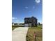 Two-story house with gray siding, a driveway, and a landscaped yard at 16 Shiloh Dr, Lillington, NC 27546