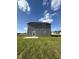 Two-story house with grey siding and backyard at 16 Shiloh Dr, Lillington, NC 27546