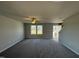 Bright living room featuring neutral walls and gray carpeting at 16 Shiloh Dr, Lillington, NC 27546
