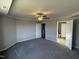 Large main bedroom with gray carpet, ceiling fan, and access to bathroom at 16 Shiloh Dr, Lillington, NC 27546