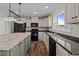 Modern kitchen with island and stainless steel appliances at 261 Willifords Pt Dr, Roxboro, NC 27574