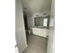 Bathroom featuring double vanity, modern fixtures, and tiled floors and shower at 2405 Englemann Dr # 121, Apex, NC 27502