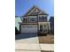 Charming new construction home with a stone facade, two-car garage, and classic black shutters at 2405 Englemann Dr # 121, Apex, NC 27502