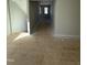 Hallway with neutral walls leads to rooms with ample space and natural light at 2405 Englemann Dr # 121, Apex, NC 27502