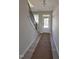 Inviting hallway with staircase, hardwood floors and natural light, leading to the home's entrance at 2405 Englemann Dr # 121, Apex, NC 27502