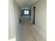 Hallway with neutral walls leads to rooms with ample space and natural light at 2405 Englemann Dr # 121, Apex, NC 27502