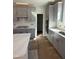 Modern kitchen with gray cabinetry, quartz countertops, and stainless steel appliances at 2405 Englemann Dr # 121, Apex, NC 27502