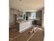 Spacious kitchen with gray cabinets, a large center island, and stainless steel appliances at 2405 Englemann Dr # 121, Apex, NC 27502