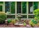 Well-maintained backyard featuring a stone bird bath surrounded by decorative plants and trees at 241 Serenity Hill Cir, Chapel Hill, NC 27516