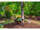 Beautiful backyard with a wheelbarrow planter and decorative wind spinner at 241 Serenity Hill Cir, Chapel Hill, NC 27516