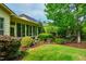 Well-maintained backyard with lush lawn, mature trees, and a sunroom on the home's exterior at 241 Serenity Hill Cir, Chapel Hill, NC 27516