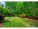 Expansive backyard with mature trees and manicured landscaping at 241 Serenity Hill Cir, Chapel Hill, NC 27516