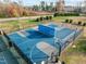 Aerial view of the community basketball and sports courts with fencing and mature trees at 241 Serenity Hill Cir, Chapel Hill, NC 27516