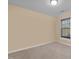 Simple bedroom with neutral carpet, light-colored walls, and a window with dark blinds at 241 Serenity Hill Cir, Chapel Hill, NC 27516
