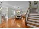 The dining room has hardwood flooring, shuttered windows, a stylish chandelier, and is open to the staircase at 241 Serenity Hill Cir, Chapel Hill, NC 27516