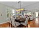 Bright dining room with large windows, hardwood floors and an ornate light fixture at 241 Serenity Hill Cir, Chapel Hill, NC 27516
