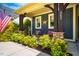 The inviting front porch has elegant wooden supports, attractive stone accents, cute chairs, and colorful landscaping at 241 Serenity Hill Cir, Chapel Hill, NC 27516