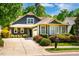 Inviting home features neat landscaping, a concrete driveway, and a cozy front porch at 241 Serenity Hill Cir, Chapel Hill, NC 27516