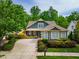 Charming home with a well-manicured front yard, a concrete driveway and mature trees creating a beautiful curb appeal at 241 Serenity Hill Cir, Chapel Hill, NC 27516