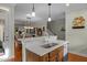 Kitchen island with stainless steel sink and dishwasher, opens up to a dining and living room area at 241 Serenity Hill Cir, Chapel Hill, NC 27516