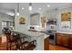 The gourmet kitchen has a stylish island with bar seating, modern appliances, hardwood flooring, and cabinetry at 241 Serenity Hill Cir, Chapel Hill, NC 27516