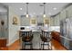 A bright kitchen with stainless steel appliances, hardwood floors, and a counter with barstool seating at 241 Serenity Hill Cir, Chapel Hill, NC 27516