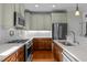 An updated kitchen boasts stainless steel appliances, updated counters and tile backsplash, and a gas cooktop at 241 Serenity Hill Cir, Chapel Hill, NC 27516