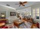 Open-concept living room features hardwood floors, a ceiling fan, and an adjacent dining area at 241 Serenity Hill Cir, Chapel Hill, NC 27516