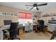 Functional home office featuring multiple workstations, ceiling fan, and built-in shelving at 241 Serenity Hill Cir, Chapel Hill, NC 27516