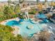 Community pool area with a waterslide, splash pad, and various seating areas with shade at 241 Serenity Hill Cir, Chapel Hill, NC 27516