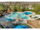 Aerial view of community pool featuring a waterslide, wading area, and shaded lounge area at 241 Serenity Hill Cir, Chapel Hill, NC 27516