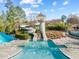 The community pool slide is featured in this outdoor shot with bright blue sky and green trees at 241 Serenity Hill Cir, Chapel Hill, NC 27516