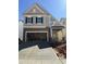 Charming two-story home with stone accents, an open garage and covered front entry at 2413 Englemann Dr # 119, Apex, NC 27502