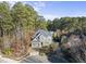 Two-story house nestled in a wooded lot, featuring a gray exterior and a paved driveway at 2500 Shadow Hills Ct Ct, Raleigh, NC 27612