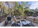 Patio with fire pit and seating area near woods at 2500 Shadow Hills Ct Ct, Raleigh, NC 27612